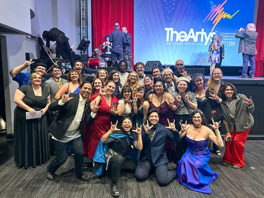Cast and crew members celebrate each other's achievements in the performing arts at the Arty Awards on October 20, 2024. In honor of the innovative, immersive ASL-interpretation that was provided during every performance of Anything Goes, SCT members show the ASL sign for 