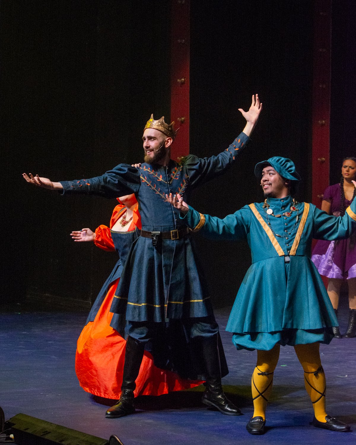 People performing on stage in costume