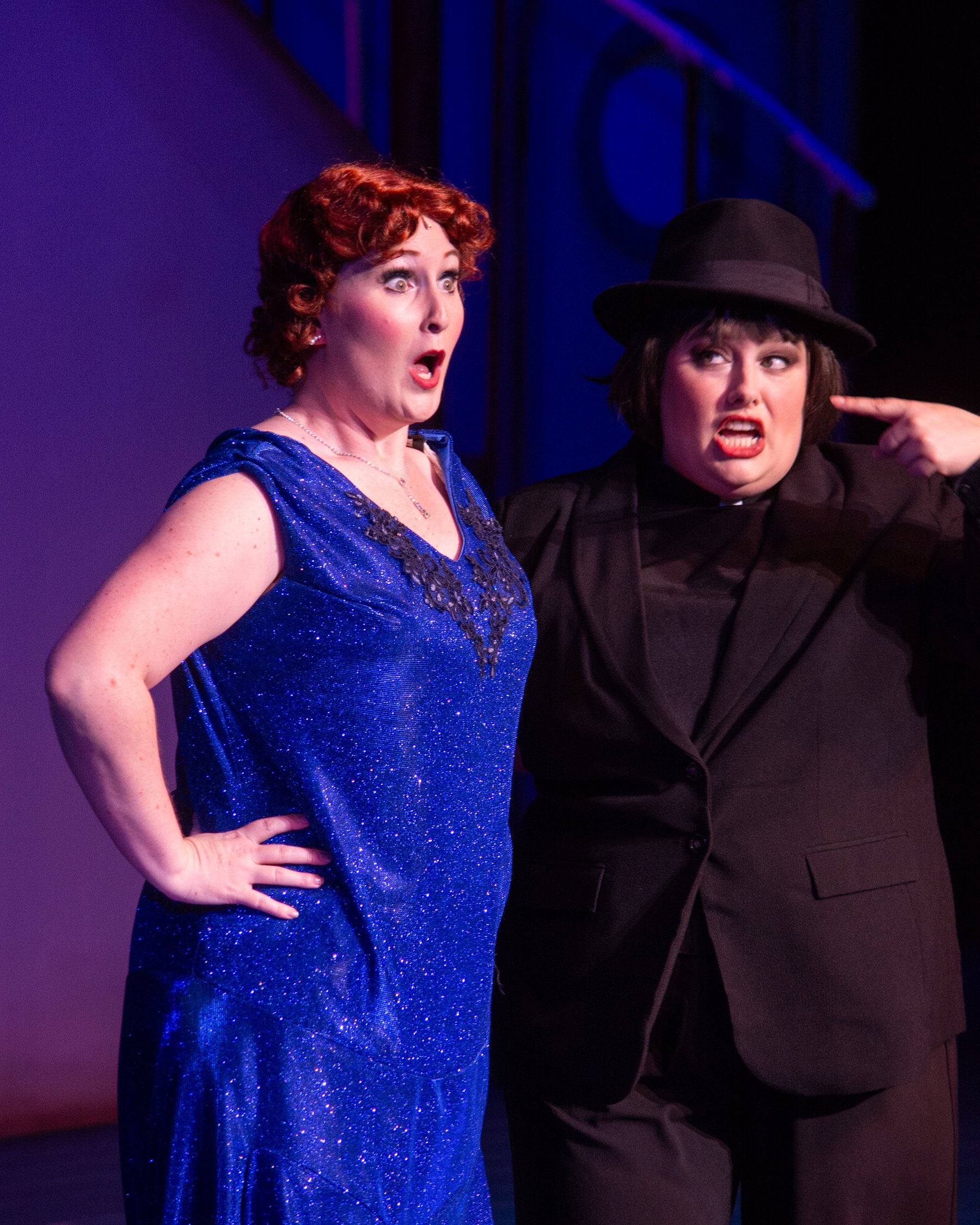 Two people performaing on stage in costume