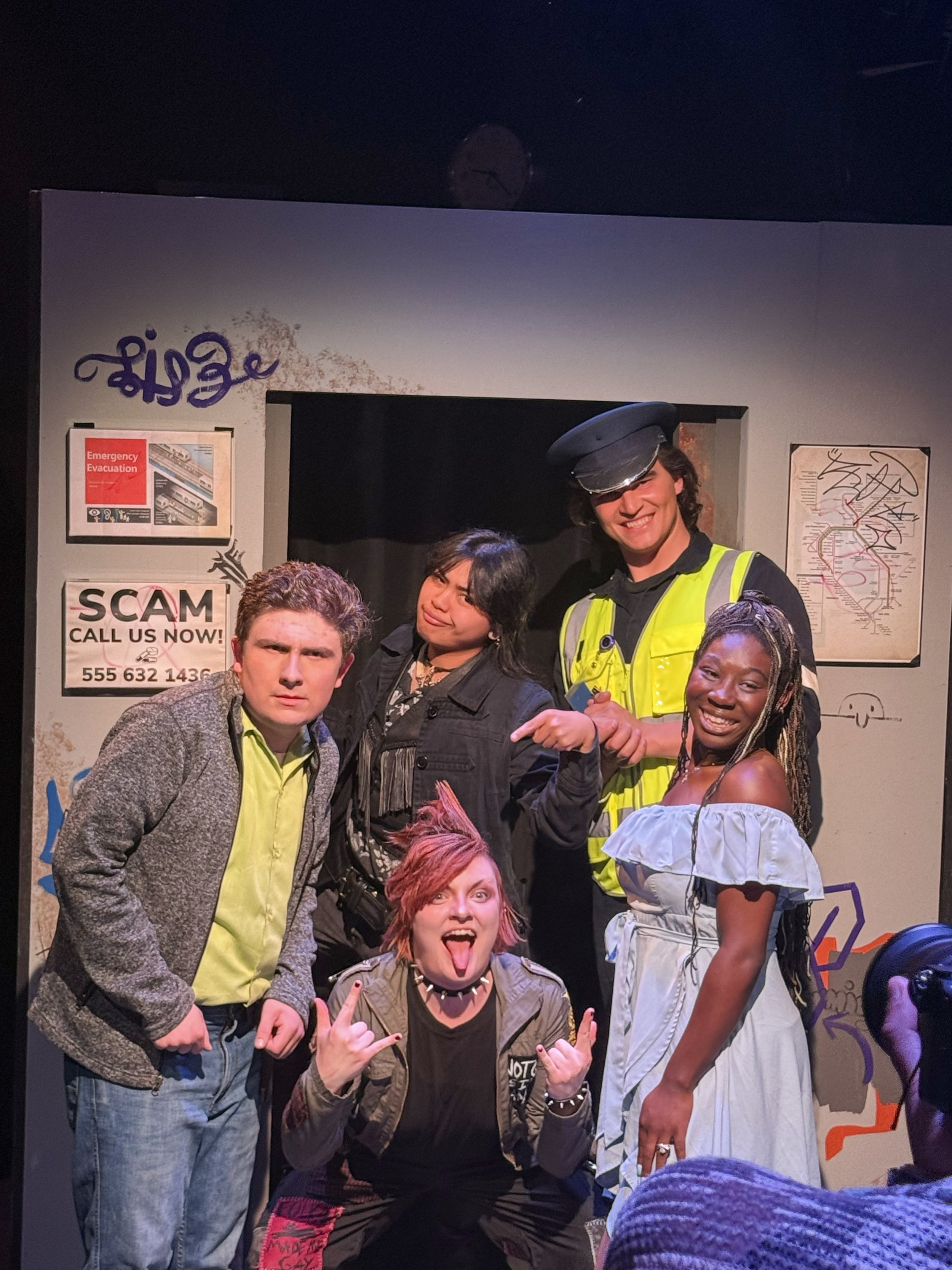 People posing on stage