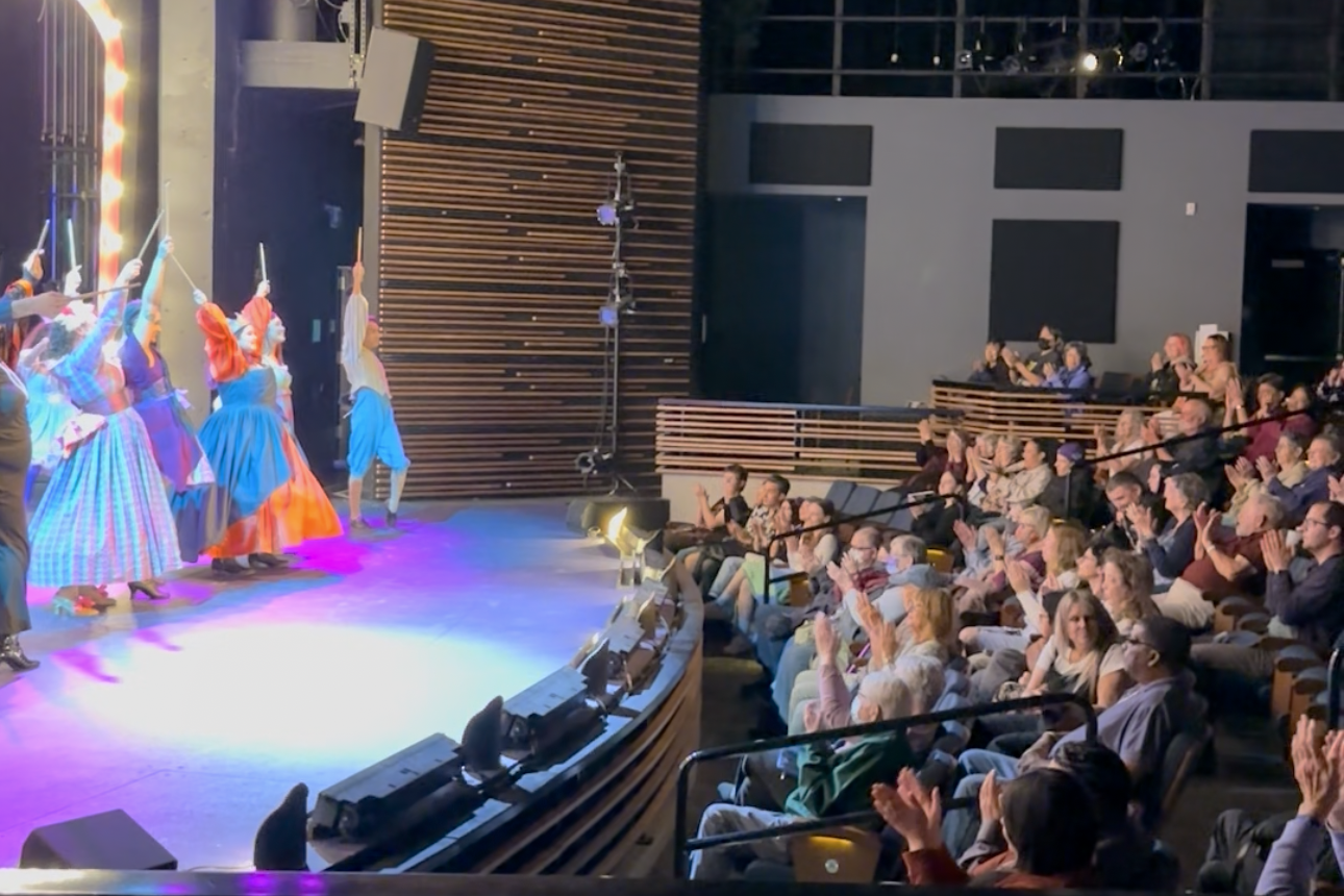 Actors bowing on stage for audience