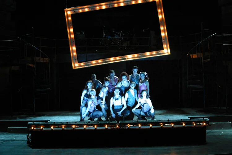 Cast on stage in front of lights