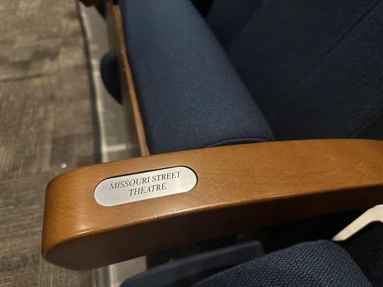 Arm rest of theatre chair with a personalized plaque