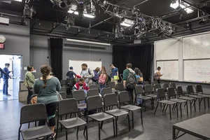 Group of students in room with chairs